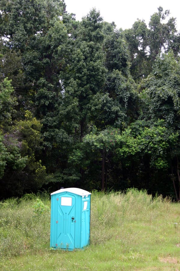 Portable outhouse in a vacant lot. Portable outhouse in a vacant lot