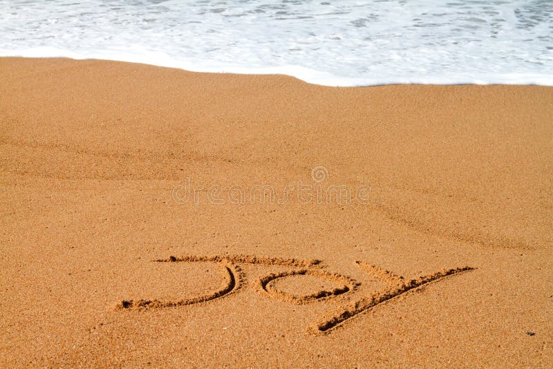 The word joy written on the beach in the sand. The word joy written on the beach in the sand