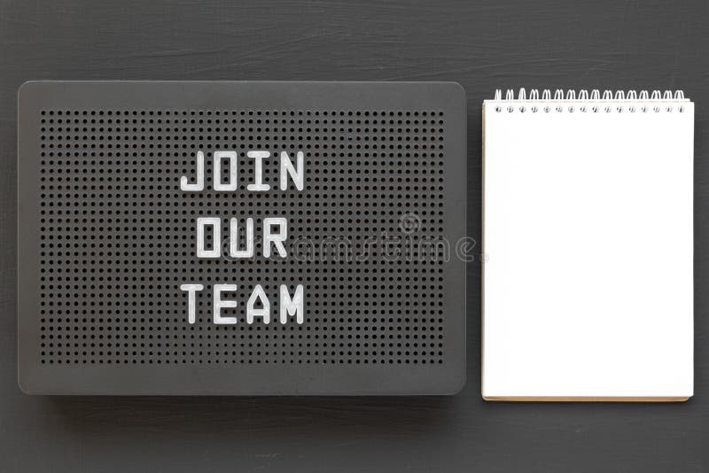 `Join our team` words on a black lightbox, blank notepad on a black background, top view. Flat lay, overhead, from above stock photos