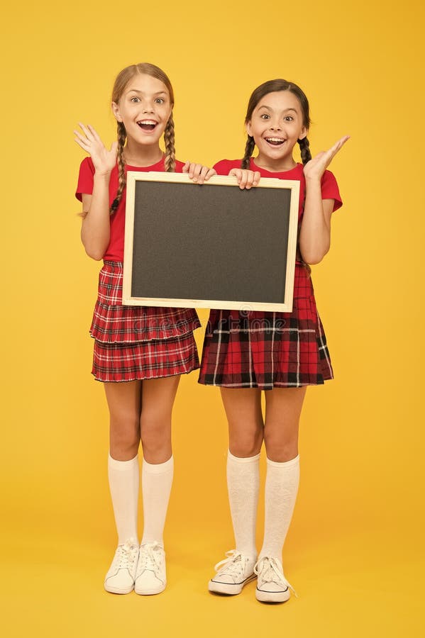 Join school club. Pupils community. Cheerleading classes. School schedule. School girls cute pupils red uniform hold stock photo