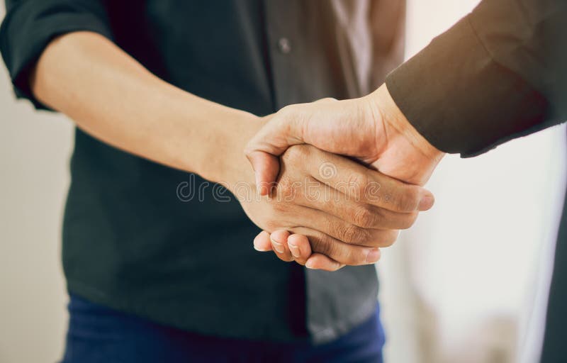 Joint Hands of Two Businessmen After Negotiating a Successful Business Agreement, And the handshake together. This is to promote cooperation in the joint stock photo