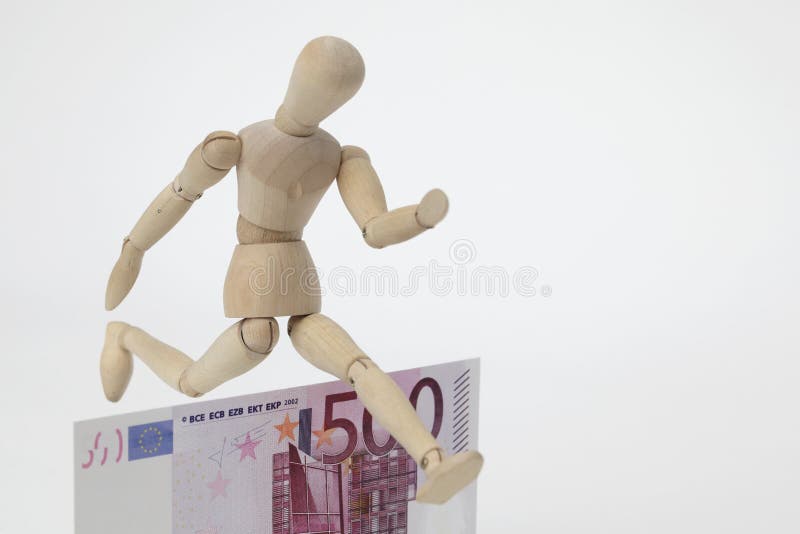 Jointed doll jumping over a 500-Euro-Banknote