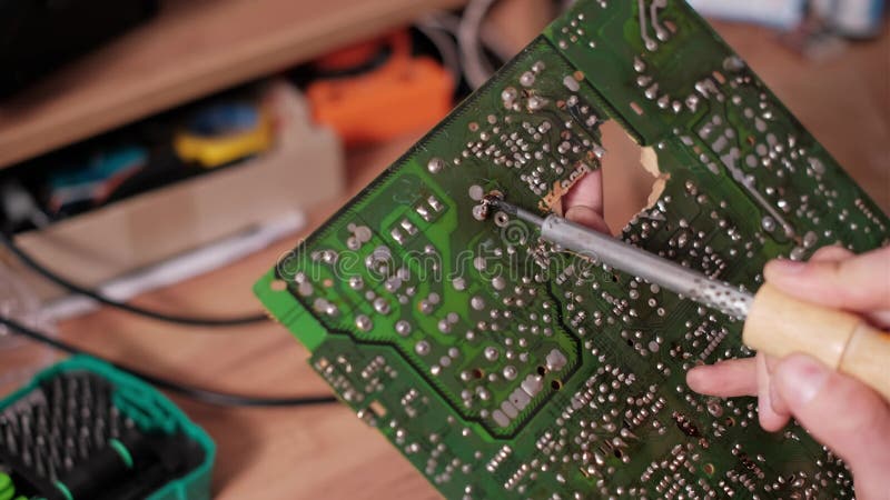 Joints de soudeur de fusion de technicien sur carte de circuit vert banque de vidéos