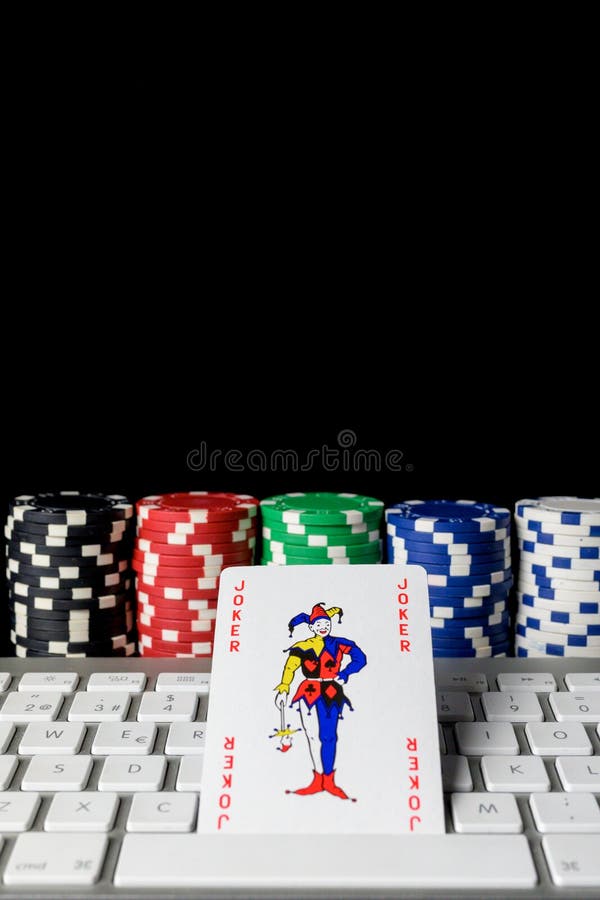 JOKER Poker Card on a Computer Keyboard with Poker Chips Placed in