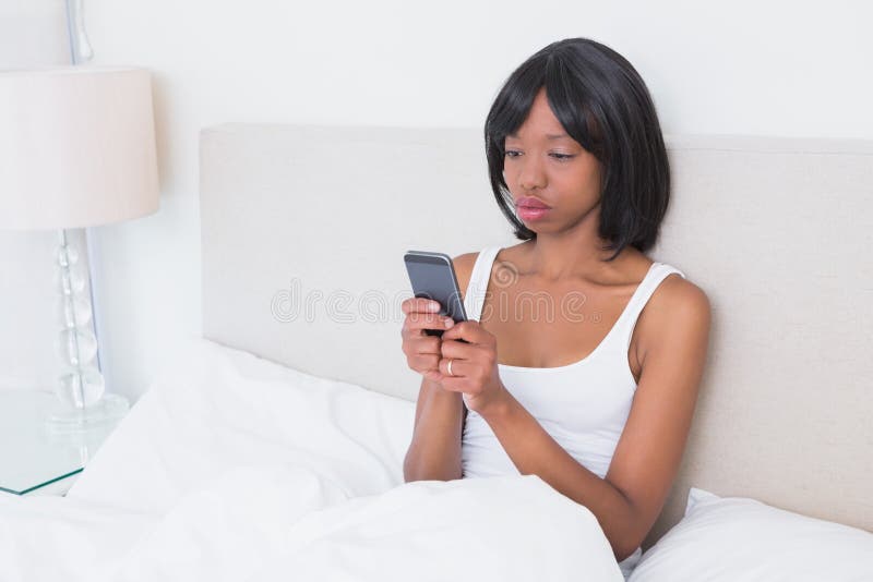 Download Jolie Femme De Brune à L'aide De Son Téléphone Portable Dans Son Lit Photo stock - Image du foncé, détente: 56484726