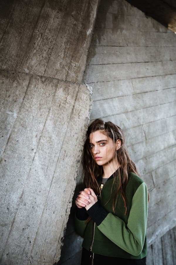 Jolie jeune femme se tenant et posant dehors regarder l'appareil-photo images libres de droits Jolie jeune femme se tenant et posant dehors regarder l'appareil-photo images libres de droits