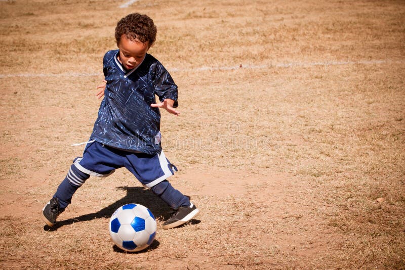 Jong Afrikaans Amerikaans jongens speelvoetbal royalty-vrije stock foto Jong Afrikaans Amerikaans jongens speelvoetbal royalty-vrije stock foto