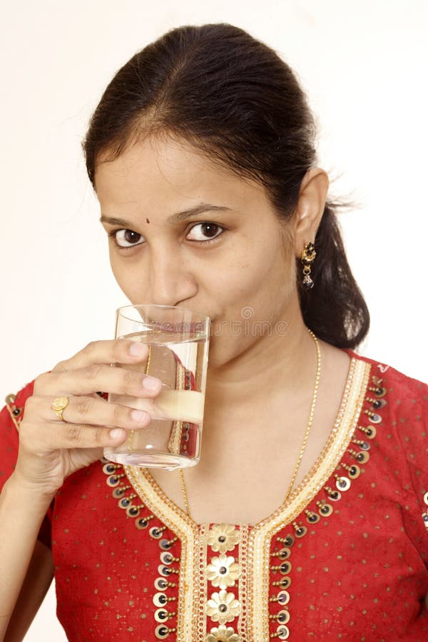 Young woman drinking water against to white. Young woman drinking water against to white