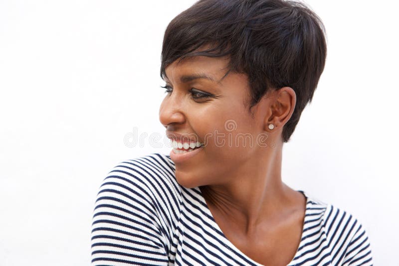 Close up portrait of a young african american woman smiling and looking away. Close up portrait of a young african american woman smiling and looking away