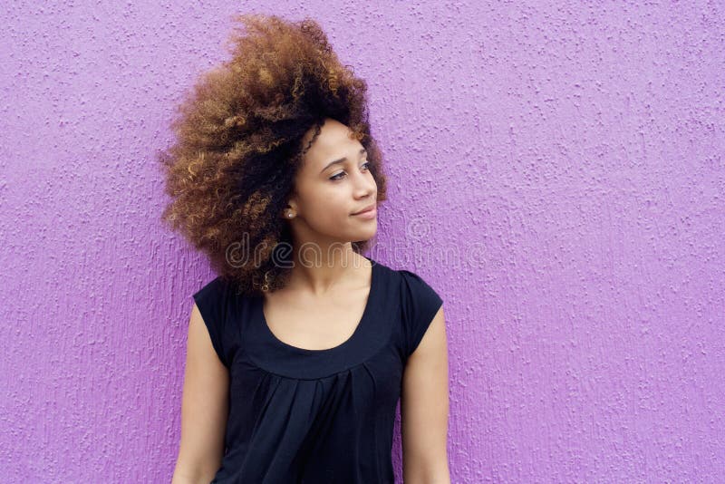 Portrait of young african woman thinking and looking away. Portrait of young african woman thinking and looking away