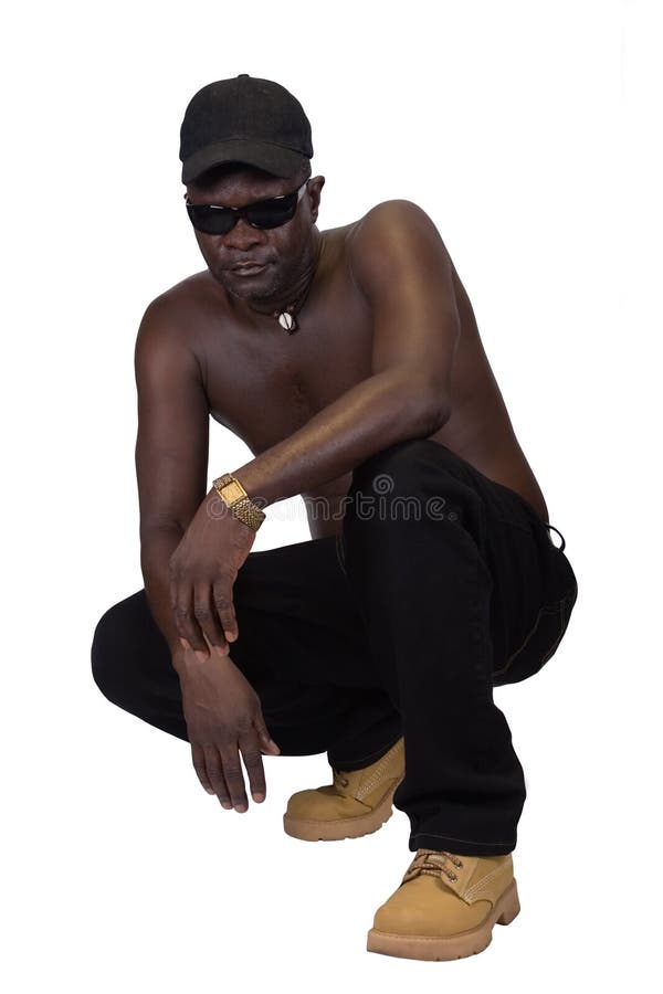 Isolated African man, Sierra Leone, black trousers and cap, rapper style. Isolated African man, Sierra Leone, black trousers and cap, rapper style