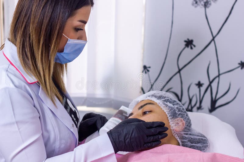 The young cosmetologist with a medical mask in spa salon. The young cosmetologist with a medical mask in spa salon