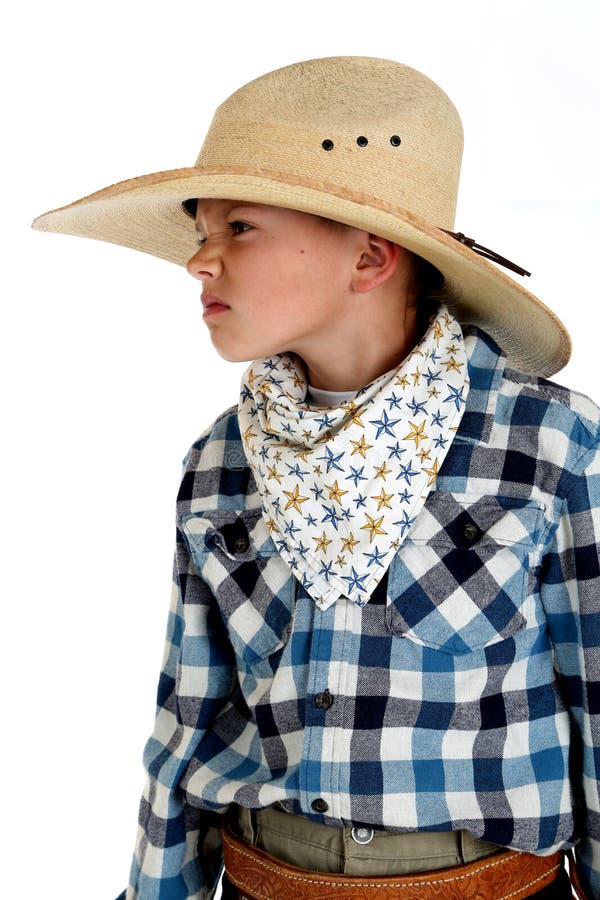 Jonge cowboy met een het grijnslachen uitdrukking die een reusachtige cowboy Ha dragen royalty-vrije stock afbeeldingen Jonge cowboy met een het grijnslachen uitdrukking die een reusachtige cowboy Ha dragen royalty-vrije stock afbeeldingen
