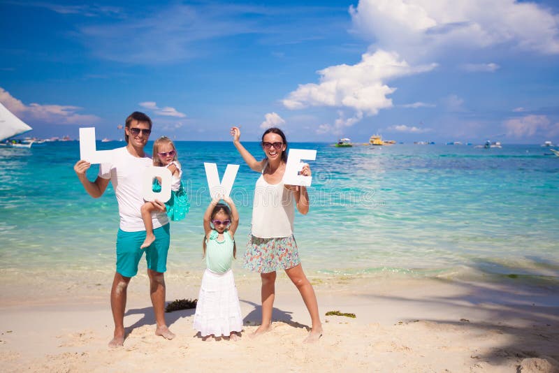 Jonge familie en twee jonge geitjes met woordliefde royalty-vrije stock foto Jonge familie en twee jonge geitjes met woordliefde royalty-vrije stock foto
