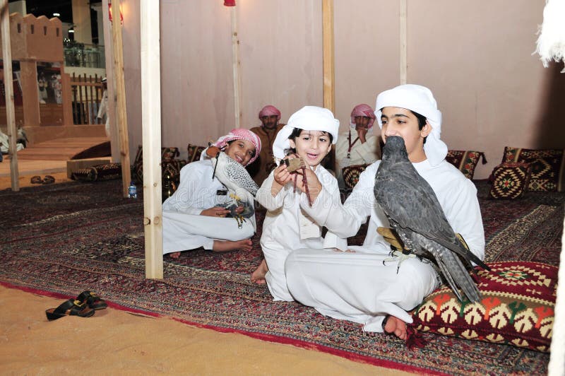 Kids with Falcon on their hand in Abu Dhabi International Hunting and Equestrian Exhibition &#x28;ADIHEX&#x29;. Kids with Falcon on their hand in Abu Dhabi International Hunting and Equestrian Exhibition &#x28;ADIHEX&#x29;