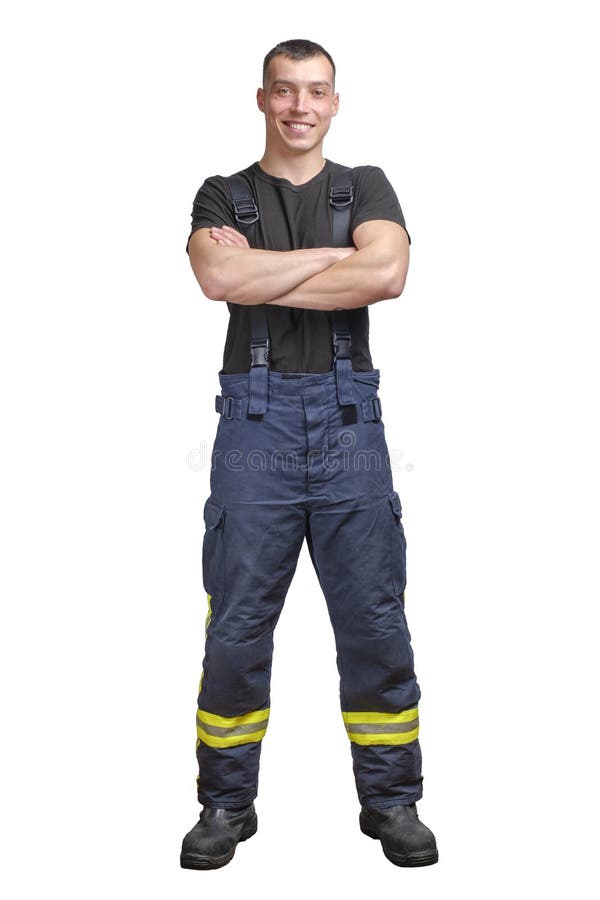 Jonge glimlachende brandweerman met gevouwen wapens met een zwart T-shirt en een vuurvaste broek met tussenrepen