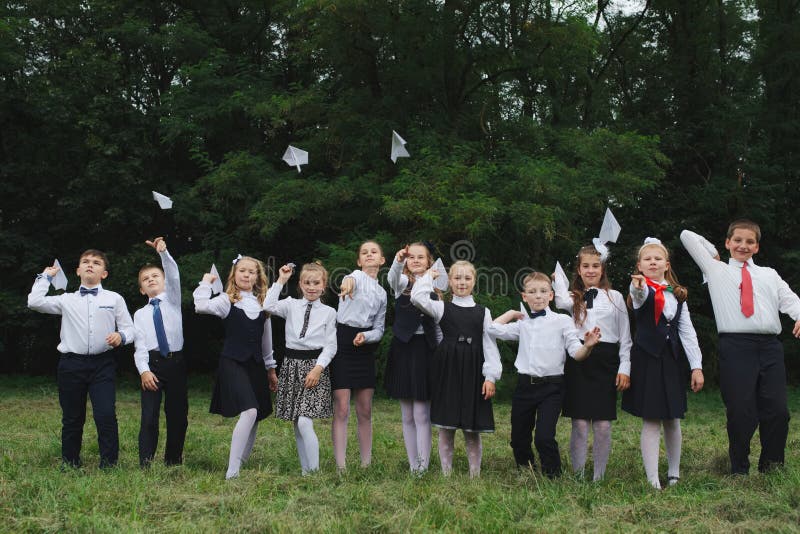 Group of young boys and girls in uniform outdoors. Group of young boys and girls in uniform outdoors