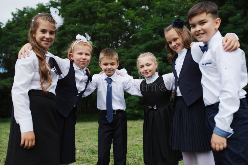 Group of young boys and girls in uniform outdoors. Group of young boys and girls in uniform outdoors