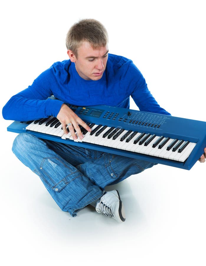 Young man with an electronic piano on a white background. Young man with an electronic piano on a white background