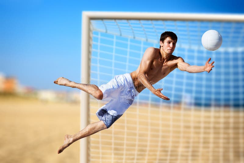 Young man playing soccer on beach. Young man playing soccer on beach.