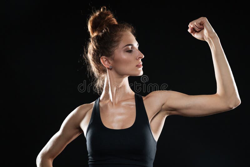 Jonge sportenvrouw die haar bicepsen tonen stock fotografie Jonge sportenvrouw die haar bicepsen tonen stock fotografie