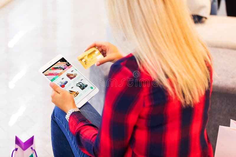 Jonge vrouw die online met tabletcomputer en creditcard winkelen royalty-vrije stock foto's Jonge vrouw die online met tabletcomputer en creditcard winkelen royalty-vrije stock foto's
