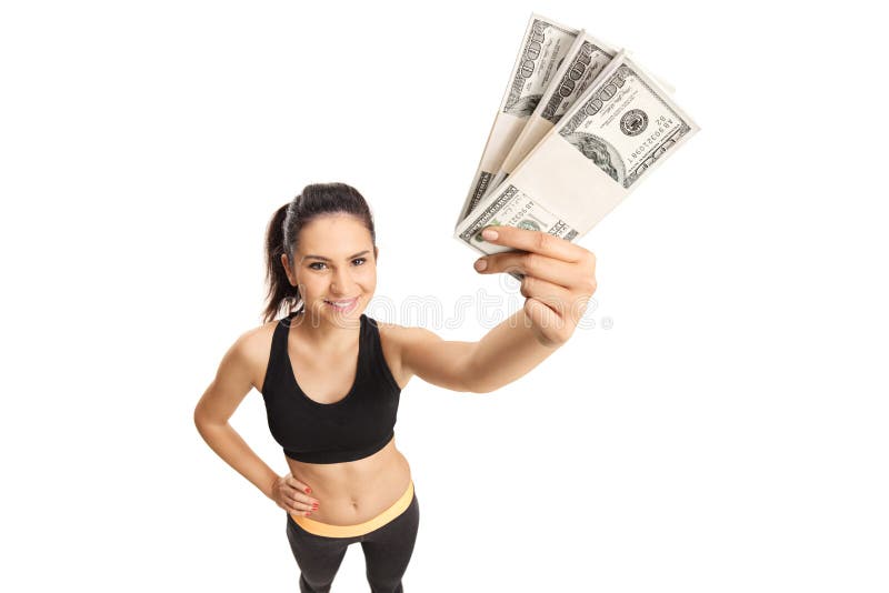 Jonge vrouw in het geld van de sportkledingsholding royalty-vrije stock afbeeldingen Jonge vrouw in het geld van de sportkledingsholding royalty-vrije stock afbeeldingen