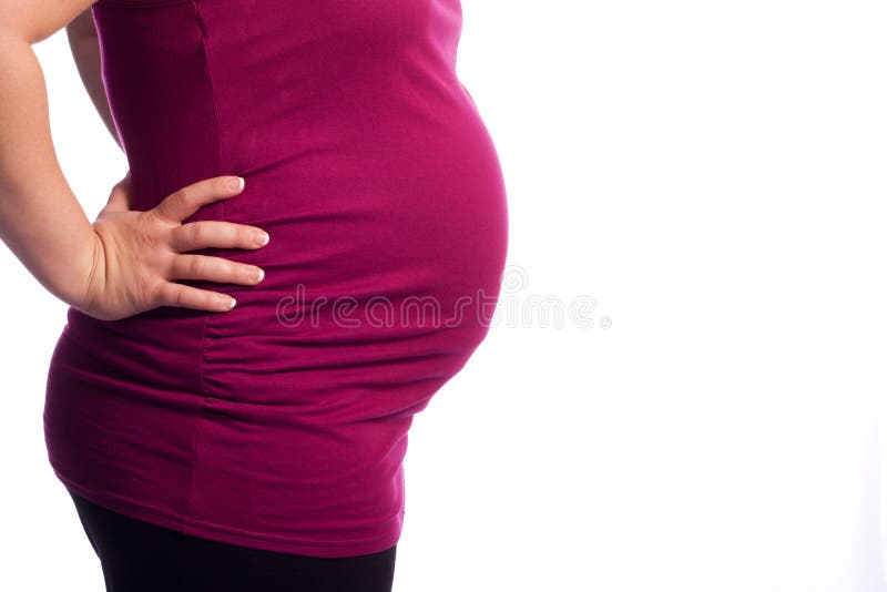 Young pregnant Caucasian woman holding her painful back. Young pregnant Caucasian woman holding her painful back