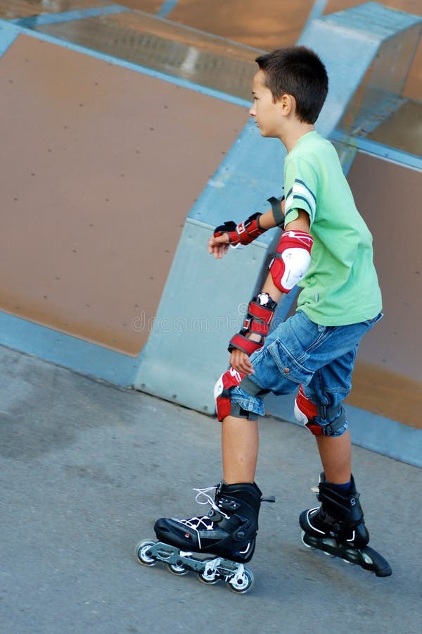 Boy roller blading in front of a ramp. Boy roller blading in front of a ramp