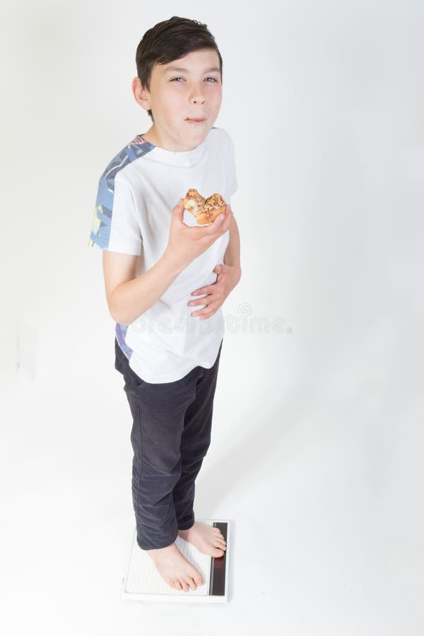 Jongen op badkamersschaal het eten royalty-vrije stock afbeeldingen Jongen op badkamersschaal het eten royalty-vrije stock afbeeldingen