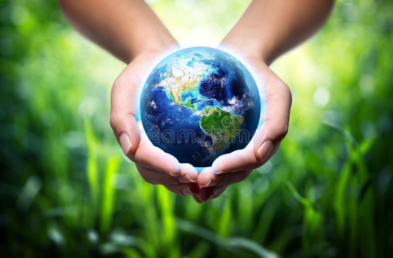 Earth in hands - grass background - environment concept - Usa. Earth in hands - grass background - environment concept - Usa