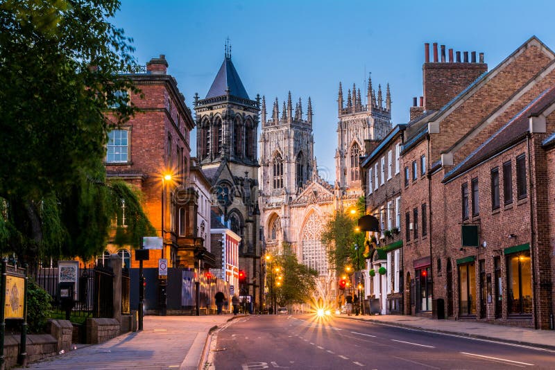 York evening cityscape view from the street with York Minster in the background. York evening cityscape view from the street with York Minster in the background.