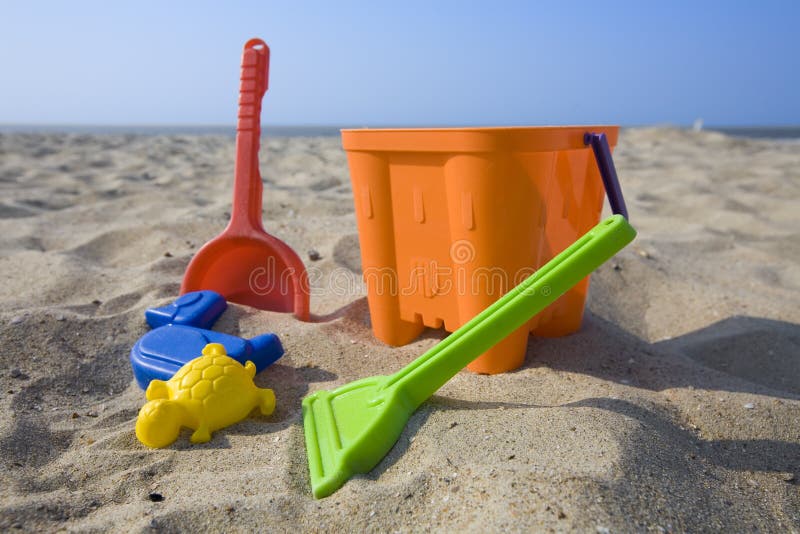 Colorful plastic beach toys : bucket and shovels. Colorful plastic beach toys : bucket and shovels