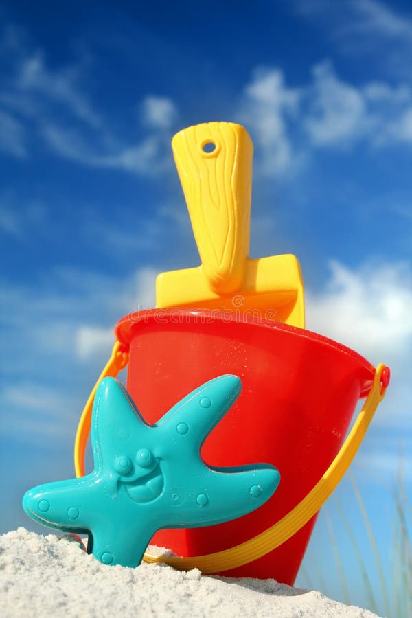 Bucket and spade on tropical beach with blue sky. Bucket and spade on tropical beach with blue sky