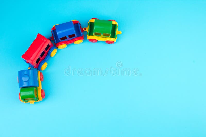 Children's toy, a multi-colored steam locomotive on a blue background. Children's toy, a multi-colored steam locomotive on a blue background