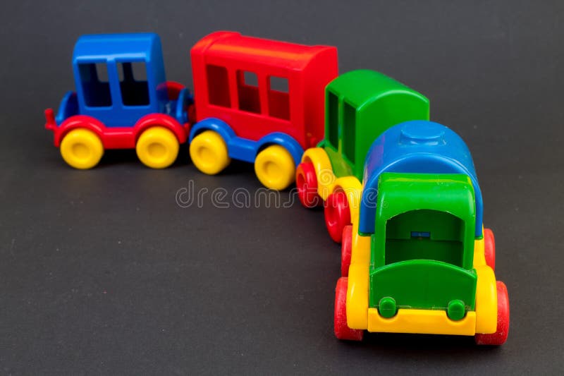 Children's toy, a multi-colored steam locomotive on a black background. For the development of the child,. Children's toy, a multi-colored steam locomotive on a black background. For the development of the child,