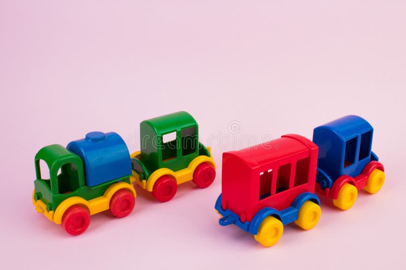 Children's toy, a multi-colored steam locomotive on a pink background. For the development of the child. Children's toy, a multi-colored steam locomotive on a pink background. For the development of the child.