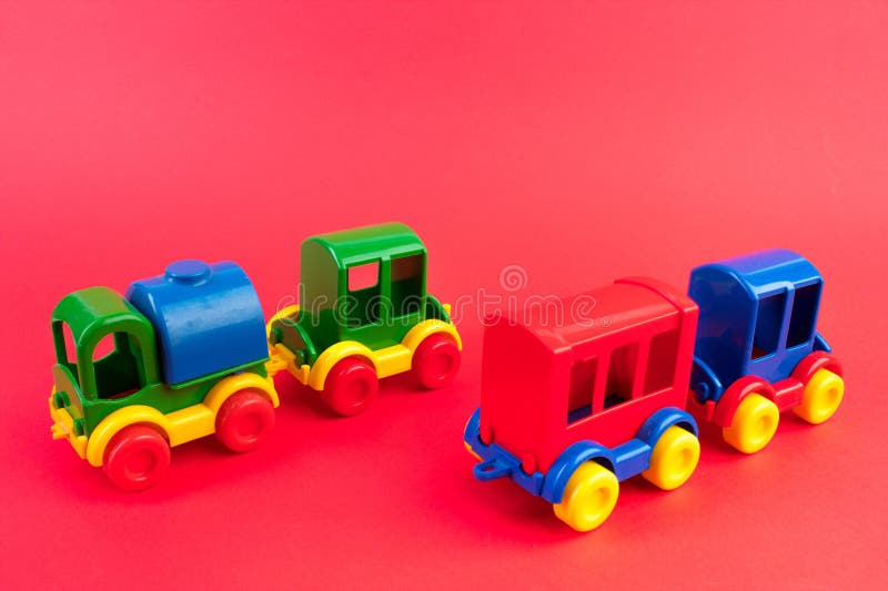 Children's toy, a multi-colored steam locomotive on a rede background. For the development of the child,. Children's toy, a multi-colored steam locomotive on a rede background. For the development of the child,