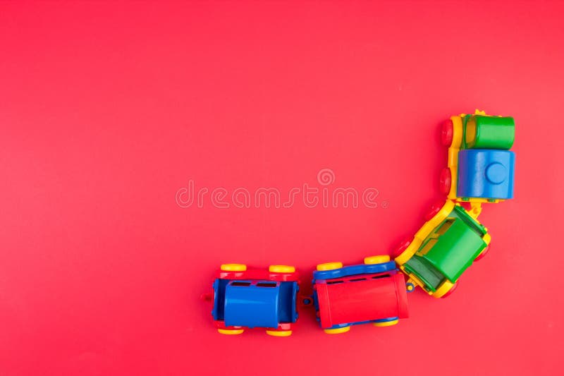 Children's toy, a multi-colored steam locomotive on a rede background. For the development of the child. Children's toy, a multi-colored steam locomotive on a rede background. For the development of the child