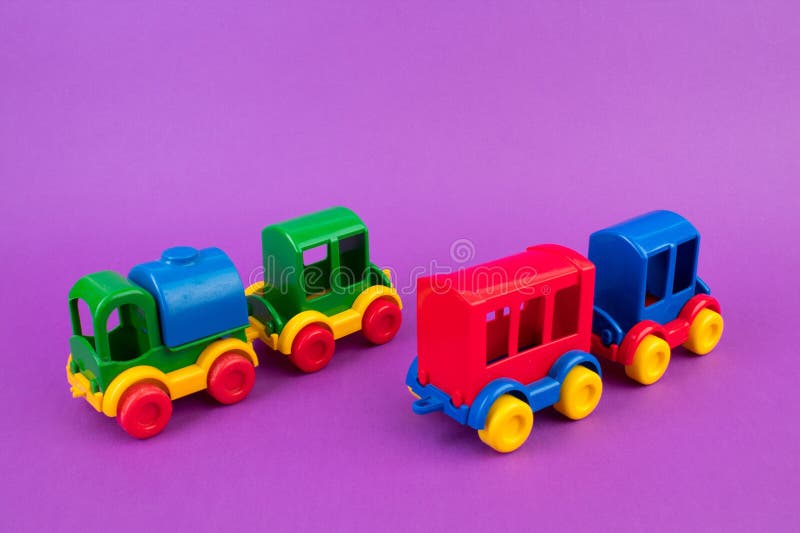 Children's toy, a multi-colored steam locomotive on a purple background,. Children's toy, a multi-colored steam locomotive on a purple background,