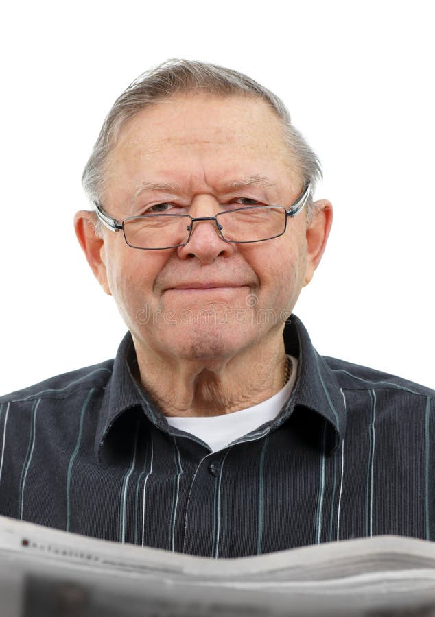 Happy senior man smiling looking up as he reads the morning's newspaper isolated on white. Happy senior man smiling looking up as he reads the morning's newspaper isolated on white