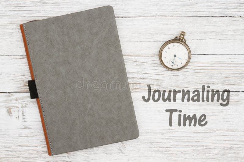 Journaling time with blank gray journal with pocket watch on a weathered whitewash wood background with copy space for your message