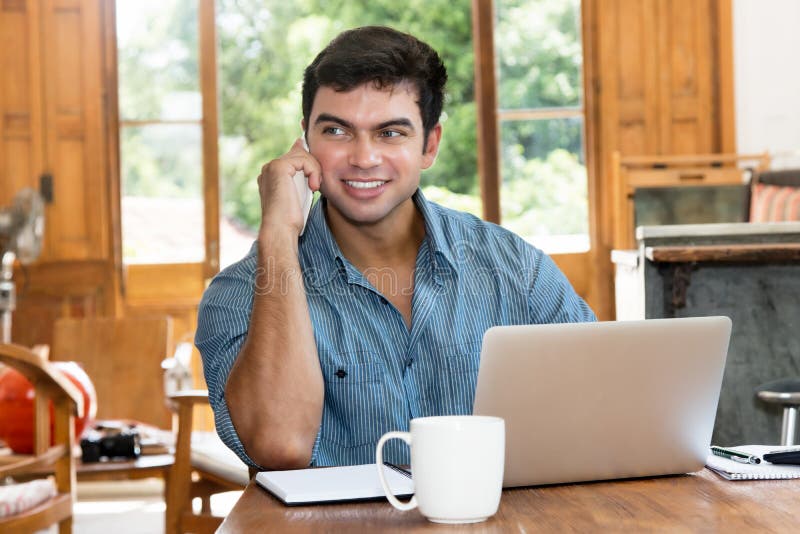 Journalist working at home with computer and mobile phone stock photography