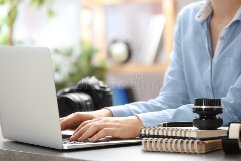 Journalist working with laptop at table stock image