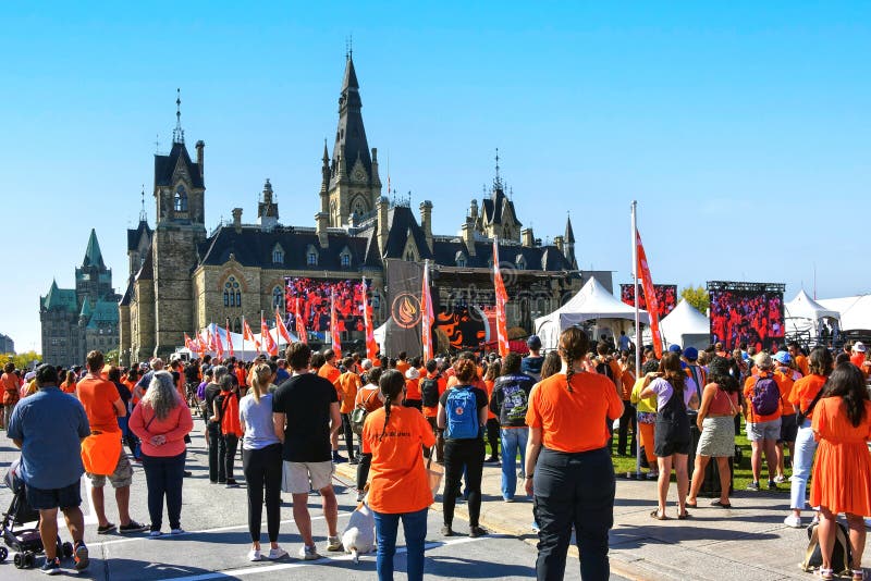 Ottawa, Canada - September 30, 2023: A crowd gathers at Parliament Hill to take in events celebrating the National Day for Truth and Reconciliation, aka Orange Shirt Day. The day honors the children who never returned home and Survivors of residential schools, as well as their families and communities and was day was declared a national holiday in 2021. Ottawa, Canada - September 30, 2023: A crowd gathers at Parliament Hill to take in events celebrating the National Day for Truth and Reconciliation, aka Orange Shirt Day. The day honors the children who never returned home and Survivors of residential schools, as well as their families and communities and was day was declared a national holiday in 2021