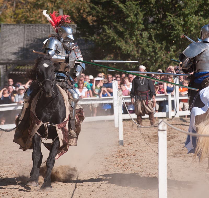 HARVEYSBURG OH, OCTOBER 9 2010 - Jousters Shane Adams and Jason Armstrong strike each other hard sending shattered lances flying at a jousting match at the Ohio Renaissance Festival, October 9, 2010.