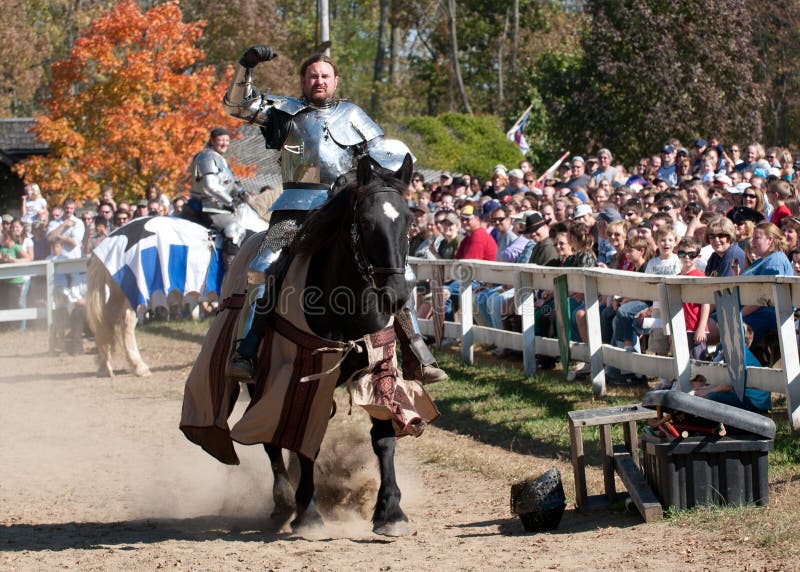 HARVEYSBURG OH,OCTOBER 9 2010- Reigning world champion Jouster Shane Adams rides in to joust while his contender, Sir Jason, looks on and smiles during the Ohio Renaissance Festival, October 9, 2010. HARVEYSBURG OH,OCTOBER 9 2010- Reigning world champion Jouster Shane Adams rides in to joust while his contender, Sir Jason, looks on and smiles during the Ohio Renaissance Festival, October 9, 2010.