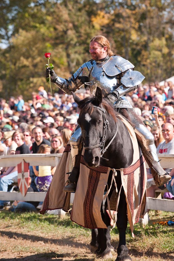 HARVEYSBURG OH,OCTOBER 9 2010- Reigning world champion Jouster Shane Adams offers a rose to a fair maiden in the crowd before a jousting match during the Ohio Renaissance Festival, October 9, 2010. HARVEYSBURG OH,OCTOBER 9 2010- Reigning world champion Jouster Shane Adams offers a rose to a fair maiden in the crowd before a jousting match during the Ohio Renaissance Festival, October 9, 2010.