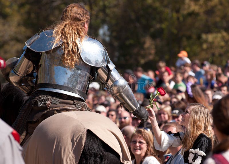 HARVEYSBURG OH,OCTOBER 9 2010- Reigning world champion Jouster Shane Adams offers a rose to a fair maiden in the crowd before a jousting match during the Ohio Renaissance Festival, October 9, 2010. HARVEYSBURG OH,OCTOBER 9 2010- Reigning world champion Jouster Shane Adams offers a rose to a fair maiden in the crowd before a jousting match during the Ohio Renaissance Festival, October 9, 2010.