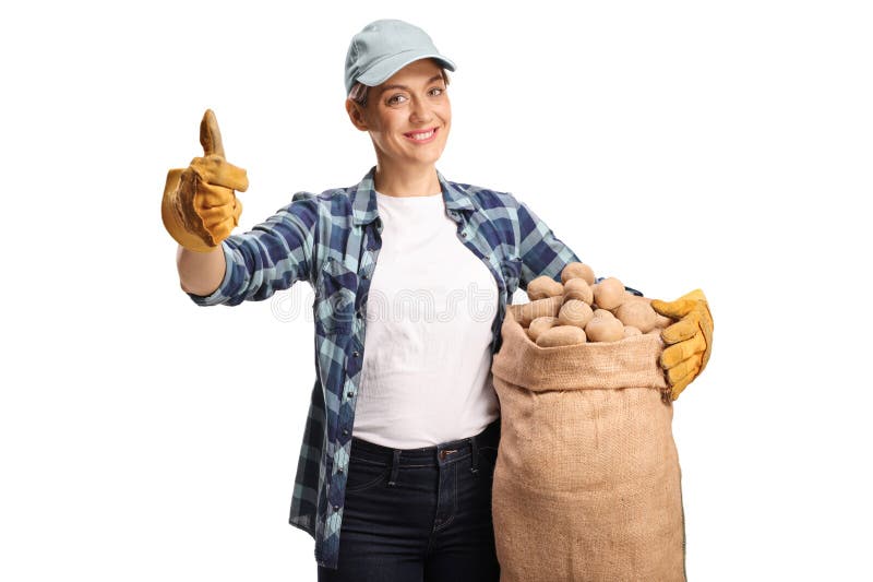 Jovem agricultora segurando batatas em saco e gestando polegares para cima foto de stock royalty free